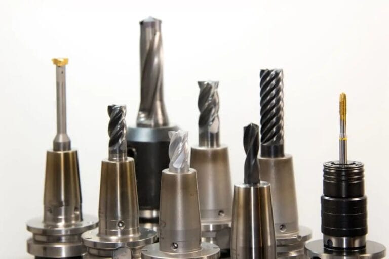 The tools used in CNC machines include drills, end mills, taps, reamers, and inserts